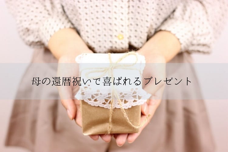 小さな手作り感のあるプレゼントボックスを両手の手の平にのせている女性