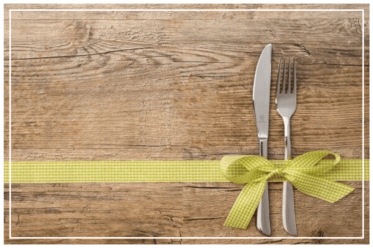 板の上にスプーンとフォークが黄色チェック柄のリボンでくっつけられている