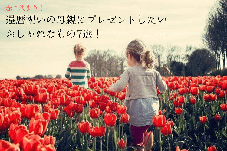 Male and female children walking in a red tulip field