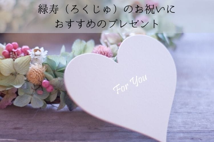 フラワーリースにfor youと書かれたハート型のメッセージカードが添えられている