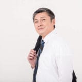 Senior men put a jacket on shoulder