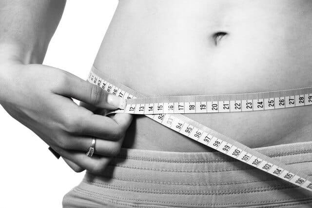 Woman measuring waist size