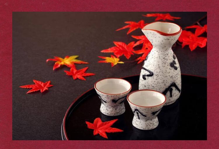 A set of small birds and sake bottles studded with maple leaves