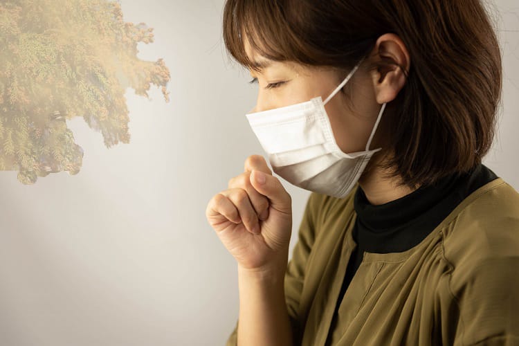 Woman wearing a mask suffering from pollen